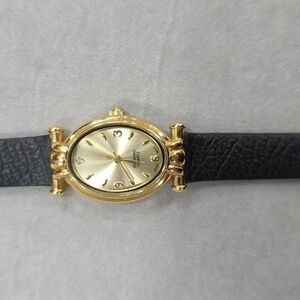 Diamond Quartz watch women's gold face black leather band stone inset at 12:00